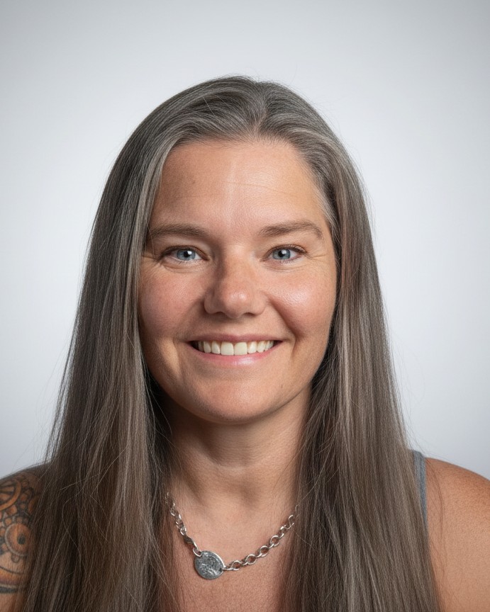Holly Quinonez, Mrs. Q, smiling, with long silver-streaked hair